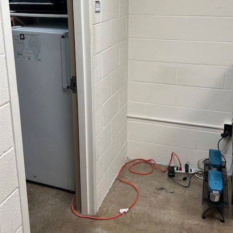 A refrigerator plugged into a power strip.